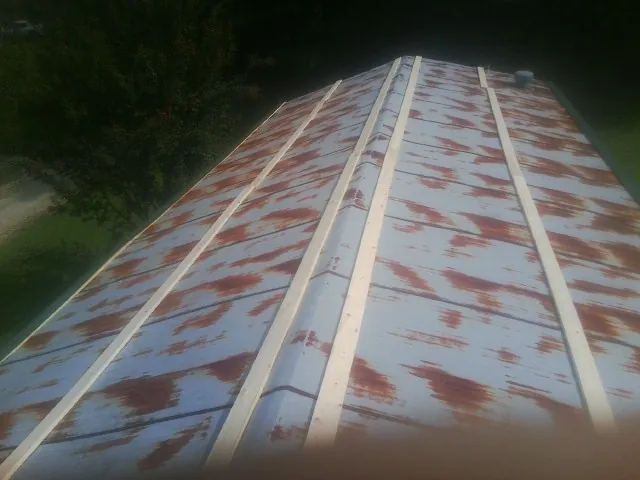 Rusted metal roof panels with new wood purlins before replacement — Storm Damage Roof Repair in Bozrah by Roofing Brothers